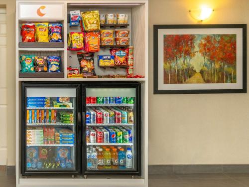 a refrigerator filled with lots of drinks and soda at Comfort Inn West in Ottawa