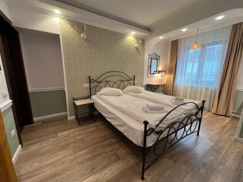 a bedroom with a large bed in a room at Hotel Boutique Cathedral Plaza Residences room for rent downtown in Bucharest