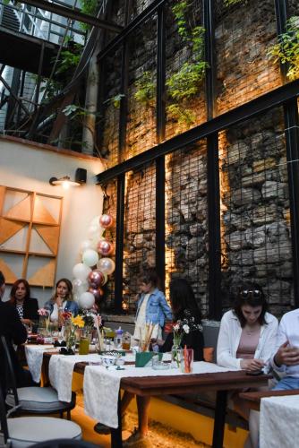 a group of people sitting at tables in a restaurant at The Marions Suite istanbul Special Category Taksim in Istanbul