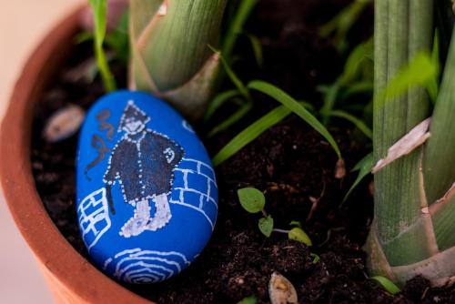 a blue painted rock sitting next to a plant at Berber Beldi Camp in Imsouane