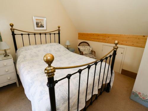a bedroom with a black bed with a white comforter at The Cider Loft in Ross on Wye