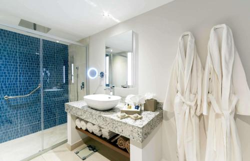 a bathroom with a tub, sink, and shower at Sonesta Ocean Point Resort- All Inclusive - Adults Only in Maho Reef