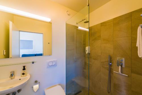a bathroom with a shower and a sink at Salthús Guesthouse in Skagaströnd
