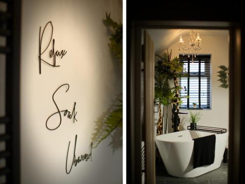 a bathroom with a tub and a sign that reads show off yourself at Beckdale in Pickering