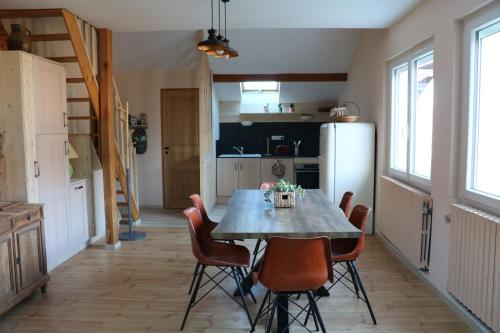 a kitchen and dining room with a table and chairs at la maison du haut de Freydon Ambiance Scandinave in Allevard