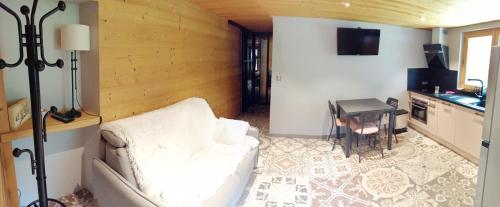 a living room with a couch and a table at Chalet Cathy et Michel in Seytroux