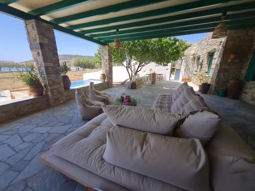 a large couch sitting on a patio at seaside Ktima KaParos PAROS in Drios