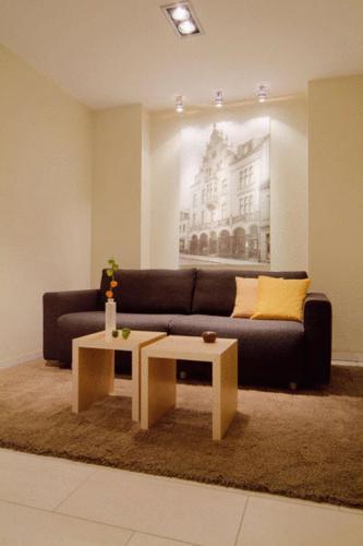 a living room with a couch and a coffee table at Gästehaus Rohleder in Velbert