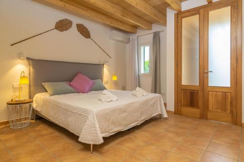 a bedroom with a bed with towels on it at Can Moreu in Port d’Andratx