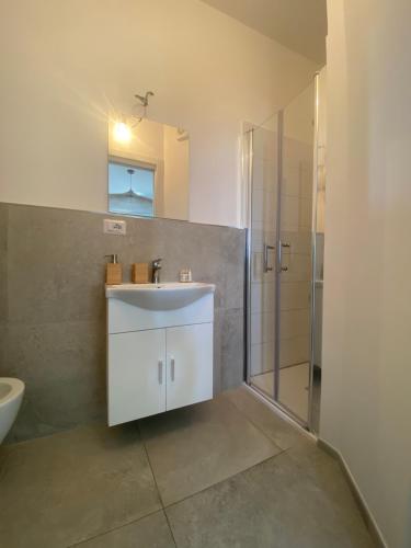 a bathroom with a white sink and a shower at Teresa Madre in Procida