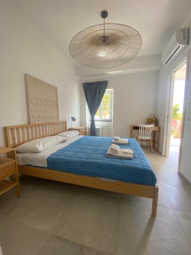 a bedroom with a large bed with a blue blanket at Teresa Madre in Procida