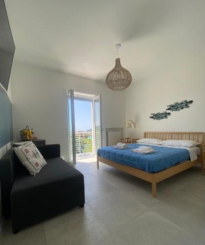a bedroom with a bed and a chair in it at Teresa Madre in Procida