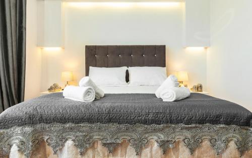 a bedroom with a large bed with towels on it at Unique Sea & Sunset Residence in Ixia
