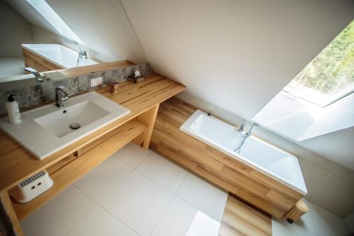 a bathroom with a sink and a mirror at Łosia Chata in Grzybowce