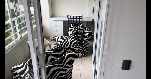 a zebra blanket sitting on a chair in a room at Departamento Cochoa Reñaca Viña del Mar Primera Línea de Playa in Viña del Mar