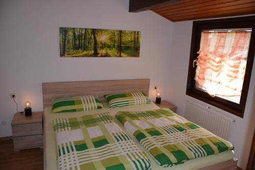 a bedroom with two beds and a window at Ferienhaus Starenweg 8 in Tennenbronn