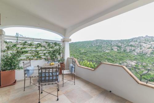 a balcony with a table and chairs and a view at Casa Elvi in Arzachena