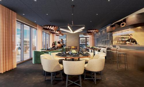 a restaurant with a table and chairs and a bar at Skarsnuten Mountain Resort & SPA in Hemsedal