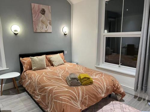 a bedroom with a bed with two towels on it at Welsh Homestay in Pembroke Dock