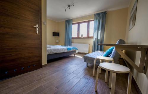 a bedroom with a bed and a couch and a table at Villa Rodzinna in Ustronie Morskie