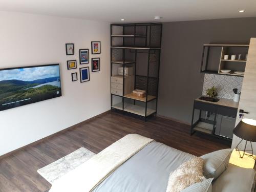 a living room with a tv on a wall at Casa Lorenzo Bogota in Bogotá