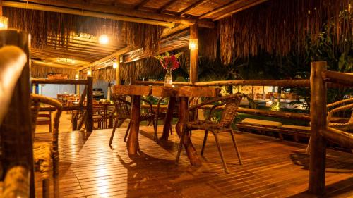 a dining room with a table and chairs in a restaurant at Pousada o Casarão in São Miguel dos Milagres