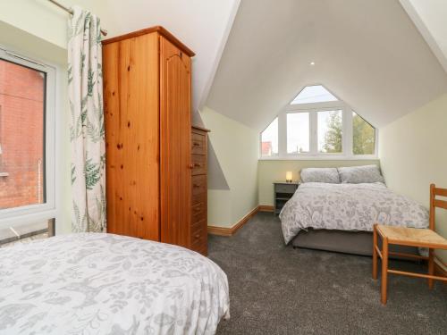 a bedroom with two beds and a window at Hill Coach House in Watchet
