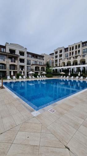 a large swimming pool in front of a building at Green Life Beach Resort- Апартамент Фемили 2 in Sozopol