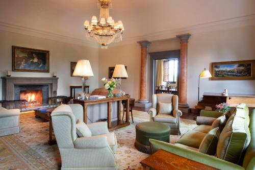 a living room with couches and chairs and a fireplace at Il Borro Relais & Châteaux in San Giustino Valdarno