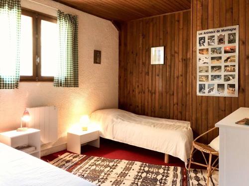 a bedroom with a bed and two tables with lamps at La bergerie d'Egat: Chalet authentique avec vue in Égat