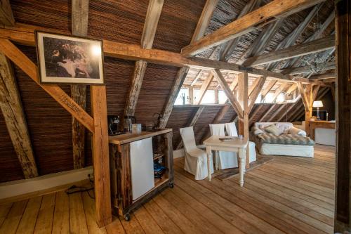 a living room with wooden ceilings and a room with a couch at Peter 7 in Görlitz
