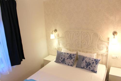 a bedroom with a white bed with two pillows at Winzerhaus Rossatz in Rossatz