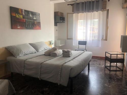a bedroom with a bed with two towels on it at B&B Cardedu in Cardedu