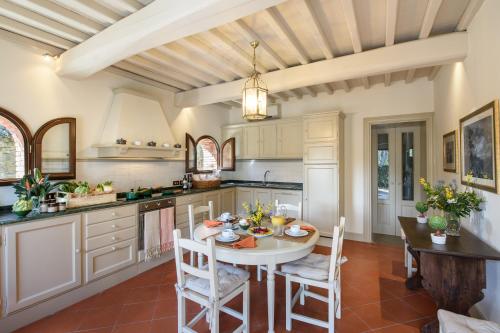 a kitchen with a table and chairs in a room at Il Borro Relais & Châteaux in San Giustino Valdarno