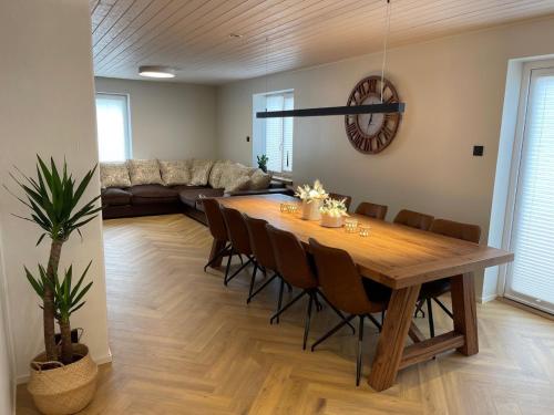 a dining room with a table and a couch at Villa Alexandra in Otepää