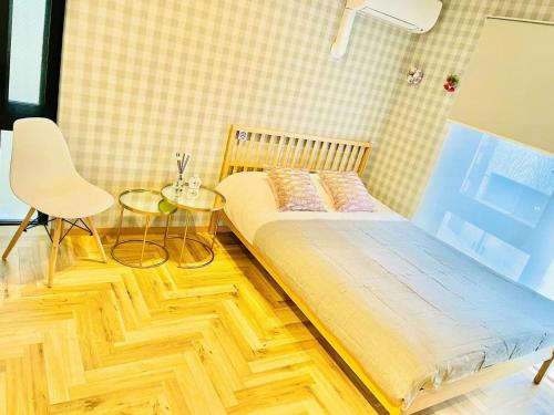 a bedroom with a bed and a table and a chair at TIME SHARING STAY Ikebukuro in Tokyo