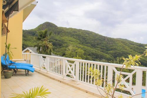 a balcony with a view of a mountain at Residence Monte-Cristo in Anse Boileau