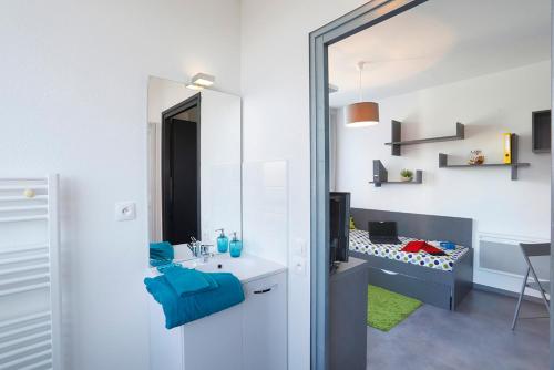 a bathroom with a sink and a mirror at Résidence Nemea Villeneuve Métropole in Villeneuve d'Ascq