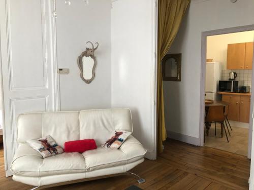 a white couch with two pillows in a living room at Le Campus Victoria I - Train Station & Isabey St - 70m2 in Nancy