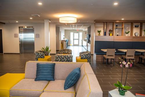 a lobby with a couch and chairs and a table at Microtel Inn & Suites by Wyndham Carlisle in Carlisle