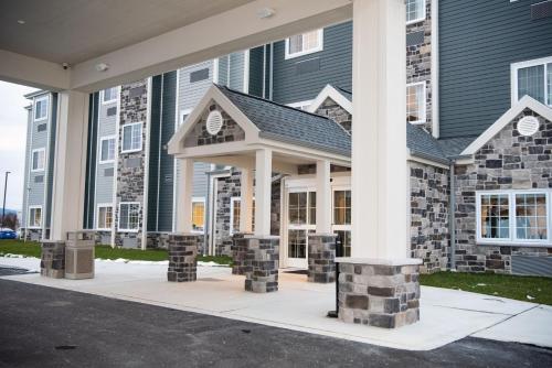 a building with stone pillars in front of it at Microtel Inn & Suites by Wyndham Carlisle in Carlisle