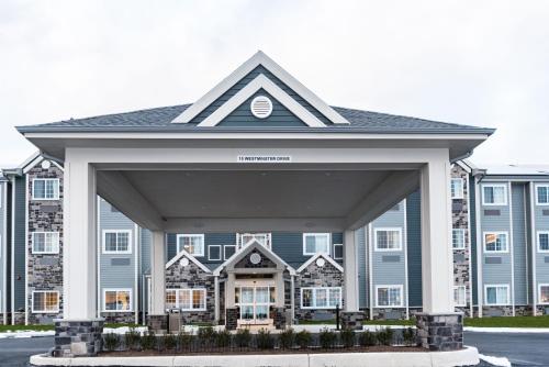 a large blue building with a large entrance at Microtel Inn & Suites by Wyndham Carlisle in Carlisle