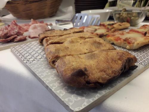 a plate of food on a table with pizza at Palazzo Favacchio - Patanè in Scicli
