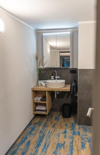 a bathroom with a sink and a mirror at Hinterm Marstall 2 in Coburg