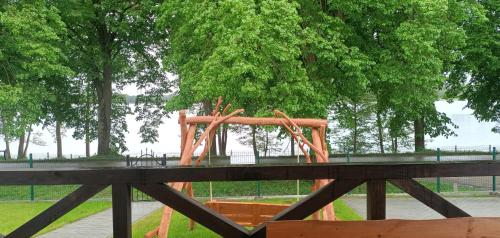 a wooden playground in a park with trees at Zielona Ostoja in Ryn