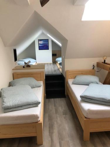 a room with two beds in a room at Farma Hvozd in Krompach