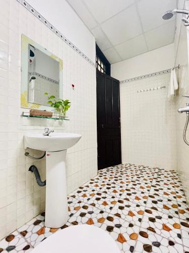 a bathroom with a sink and a toilet at Eva Homestay in Hue