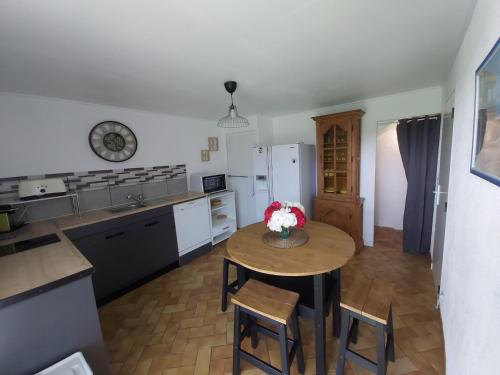 eine Küche mit einem Tisch und Stühlen im Zimmer in der Unterkunft Le Mas d'Evlie in Aubin