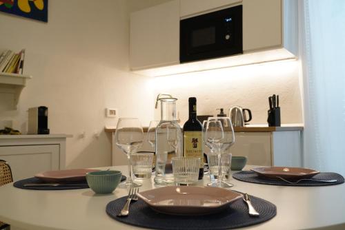 a table with glasses and a bottle of wine on it at CasaBella - con TERRAZZA PANORAMICA in Ostuni