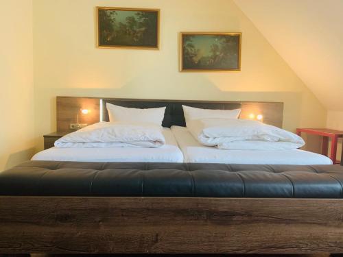 two beds with white pillows in a bedroom at Hotel-Restaurant Buger Hof in Bamberg